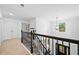 Bright hallway featuring neutral walls, carpet, and black railing, with natural light from a window at 13 Four Feathers Ln, Rydal, GA 30171