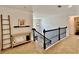 Upstairs hallway features neutral carpet, black iron railing, and decor shelves at 13 Four Feathers Ln, Rydal, GA 30171