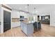 Spacious kitchen with a gray center island, stainless appliances, granite countertops, and modern pendant lighting at 13 Four Feathers Ln, Rydal, GA 30171