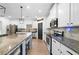 Modern kitchen with stainless steel appliances, granite countertops, a large island, and sleek white cabinets at 13 Four Feathers Ln, Rydal, GA 30171