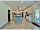 Well-lit kitchen featuring an island with seating, stainless steel appliances and sleek countertops at 13 Four Feathers Ln, Rydal, GA 30171