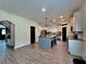 Open-concept kitchen with large island, stainless steel appliances, and modern lighting at 13 Four Feathers Ln, Rydal, GA 30171