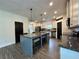 Updated kitchen featuring a central island, granite countertops, stainless appliances and modern pendant lighting at 13 Four Feathers Ln, Rydal, GA 30171