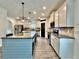 Modern kitchen with central island, granite countertops, stainless appliances, and ample cabinet space at 13 Four Feathers Ln, Rydal, GA 30171