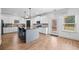 Bright, open kitchen features a large island, granite countertops, stainless steel appliances, and access to the backyard at 13 Four Feathers Ln, Rydal, GA 30171