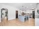 Spacious kitchen features a large center island with seating, stainless steel appliances, and modern lighting fixtures at 13 Four Feathers Ln, Rydal, GA 30171