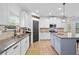 Well-lit kitchen with granite counters, stainless appliances, abundant cabinetry, and modern pendant lighting at 13 Four Feathers Ln, Rydal, GA 30171