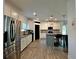 Well-lit kitchen with stainless steel refrigerator, granite counters, modern appliances, and a stylish breakfast bar at 13 Four Feathers Ln, Rydal, GA 30171