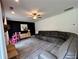 Spacious living room featuring modern black accent wall and comfortable gray couch at 13 Four Feathers Ln, Rydal, GA 30171
