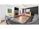 Bright living room featuring a stone fireplace, comfortable seating, with modern flooring and natural light at 13 Four Feathers Ln, Rydal, GA 30171