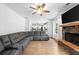 An open-concept living area is accented by a stone fireplace and flows seamlessly into the kitchen at 13 Four Feathers Ln, Rydal, GA 30171