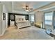 Large primary bedroom with a tray ceiling, a ceiling fan, and lots of natural light at 13 Four Feathers Ln, Rydal, GA 30171