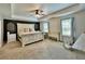 Comfortable main bedroom featuring ample natural light, a cozy seating area, and neutral decor at 13 Four Feathers Ln, Rydal, GA 30171