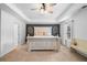 Bright main bedroom with a decorative headboard and trim, and large windows with natural light at 13 Four Feathers Ln, Rydal, GA 30171