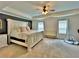 Large primary bedroom with a tray ceiling, a ceiling fan, and lots of natural light at 13 Four Feathers Ln, Rydal, GA 30171