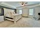 Spacious main bedroom with a trey ceiling, neutral tones, and two windows at 13 Four Feathers Ln, Rydal, GA 30171