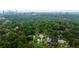 Scenic aerial shot featuring the tree-lined property with city views and luxurious swimming pool at 3212 Arden Nw Rd, Atlanta, GA 30305