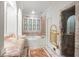 A luxurious bathroom featuring marble finishes, a soaking tub, and a glass-enclosed shower, creating a spa-like experience at 3212 Arden Nw Rd, Atlanta, GA 30305