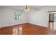 Bright bedroom with hardwood floors, ceiling fan, and large window, offering a comfortable and inviting space at 3212 Arden Nw Rd, Atlanta, GA 30305