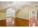 Large bonus room with sloped ceilings, hardwood floors, and a chandelier, perfect for entertaining or relaxing at 3212 Arden Nw Rd, Atlanta, GA 30305