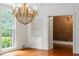 Bright dining room featuring hardwood floors, a large window, built-in shelving, and a view into another room at 3212 Arden Nw Rd, Atlanta, GA 30305