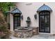 Elegant exterior detail featuring a stone fountain, arched windows, and stylish sconces at 3212 Arden Nw Rd, Atlanta, GA 30305