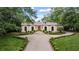 Elegant home with symmetrical facade, manicured landscaping, and a welcoming circular driveway at 3212 Arden Nw Rd, Atlanta, GA 30305