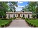 Elegant home featuring a symmetrical facade, manicured landscaping, and a grand driveway leading to the entrance at 3212 Arden Nw Rd, Atlanta, GA 30305