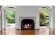 A fireplace with a stone mantel and views of the lush greenery outside at 3212 Arden Nw Rd, Atlanta, GA 30305