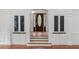 Grand foyer featuring decorative glass doors, built-in cabinets, and hardwood floors, adding character and elegance at 3212 Arden Nw Rd, Atlanta, GA 30305