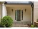 Welcoming front entrance with stone steps, stylish sconces, and a view into the foyer at 3212 Arden Nw Rd, Atlanta, GA 30305