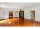 Spacious living room featuring gleaming hardwood floors, chandelier, and access to kitchen and other rooms at 3212 Arden Nw Rd, Atlanta, GA 30305