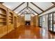 Spacious living room with a unique antler chandelier, fireplace, custom built-ins, and access to an outdoor patio at 3212 Arden Nw Rd, Atlanta, GA 30305