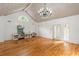 Spacious living room featuring hardwood floors, a chandelier, and a modern kitchen setup at 3212 Arden Nw Rd, Atlanta, GA 30305