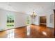 Large living room with hardwood floors, a chandelier, built-in storage, and plenty of natural light from the large windows at 3212 Arden Nw Rd, Atlanta, GA 30305