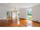 Bright and spacious living room with hardwood floors, large windows, and a decorative chandelier, offering ample natural light at 3212 Arden Nw Rd, Atlanta, GA 30305