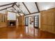 Expansive living room featuring a fireplace, beamed ceilings, custom built-ins, and seamless indoor-outdoor flow at 3212 Arden Nw Rd, Atlanta, GA 30305