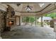 Spacious outdoor living area featuring a stone fireplace, slate floors, and scenic views of the landscaped backyard at 3212 Arden Nw Rd, Atlanta, GA 30305