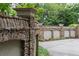 Elaborate stone wall with arched details lining the driveway and enhancing the property's curb appeal at 3212 Arden Nw Rd, Atlanta, GA 30305