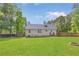 Well-maintained backyard features a fire pit, lush green lawn, and a wood privacy fence at 37 Winesap Ct, Temple, GA 30179