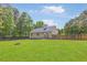 Expansive backyard with lush lawn and a fire pit, enclosed by a wood privacy fence at 37 Winesap Ct, Temple, GA 30179