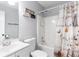 Neutral toned bathroom featuring a shower-tub combo, modern sink vanity, and decorative shower curtain at 37 Winesap Ct, Temple, GA 30179