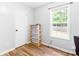 Bedroom with a large window and wood floors, featuring a storage rack at 37 Winesap Ct, Temple, GA 30179