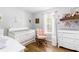 Charming Bedroom with a white crib, pink rocking chair, and floral accents creating a sweet, comforting space at 37 Winesap Ct, Temple, GA 30179