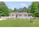 Inviting home featuring a wide front porch and well-manicured lawn at 37 Winesap Ct, Temple, GA 30179