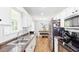Open kitchen design with stainless steel appliances, white cabinets, and dining area, perfect for Gathering meals at 37 Winesap Ct, Temple, GA 30179