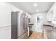 Modern kitchen features stainless steel appliances, white cabinetry, and wood floors at 37 Winesap Ct, Temple, GA 30179