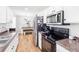 Bright kitchen showcasing stainless steel appliances, including a microwave and oven, complemented by white cabinets at 37 Winesap Ct, Temple, GA 30179