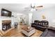 Spacious living room boasts a fireplace, hardwood floors, and comfortable seating at 37 Winesap Ct, Temple, GA 30179