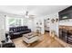 Cozy living room with hardwood floors, fireplace, and comfortable furnishings at 37 Winesap Ct, Temple, GA 30179